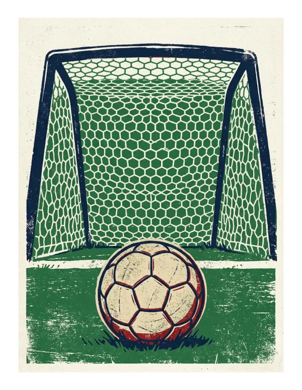 A soccer ball sits on green grass in front of a soccer goal net with hexagonal patterns.