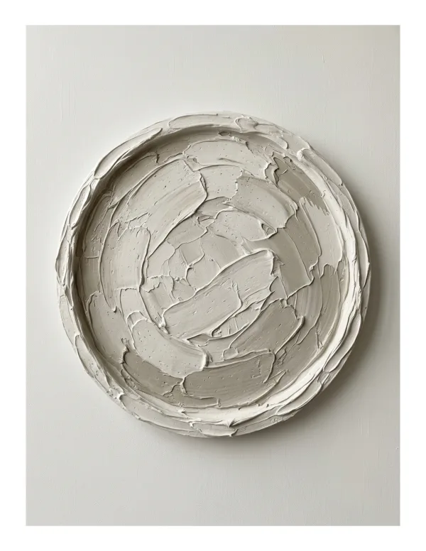 Circular plaster disc with thick, textured strokes arranged in a spiral pattern on a white background.